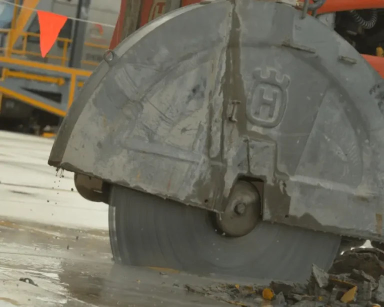 close up of a concrete sawing machine cutting concrete