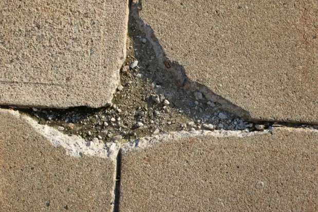 image showing broken concrete slab with bits missing